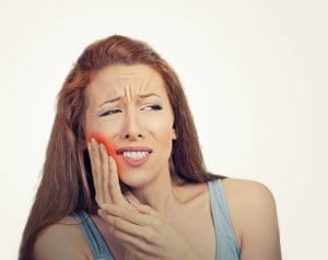'woman in pain after wisdom tooth extraction'