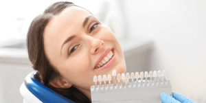 woman in dental chair with color match palate