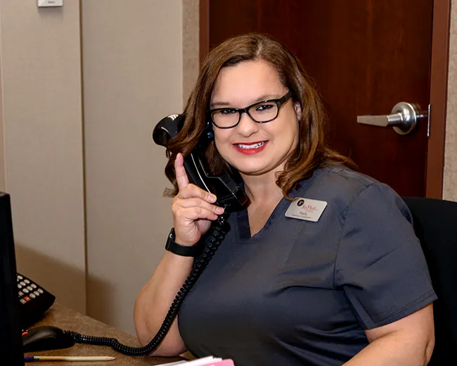 Female Financial Coordinator talking on the phone helping a patient