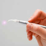 Hand holding a dental laser aperature LANAP Dental Laser Treatments Minimally Invasive