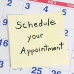 Schedule an appointment reminder on a sticky note on a calendar.