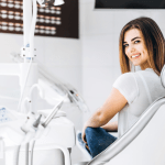 Woman looking over her shoulder smiling in a dental chair